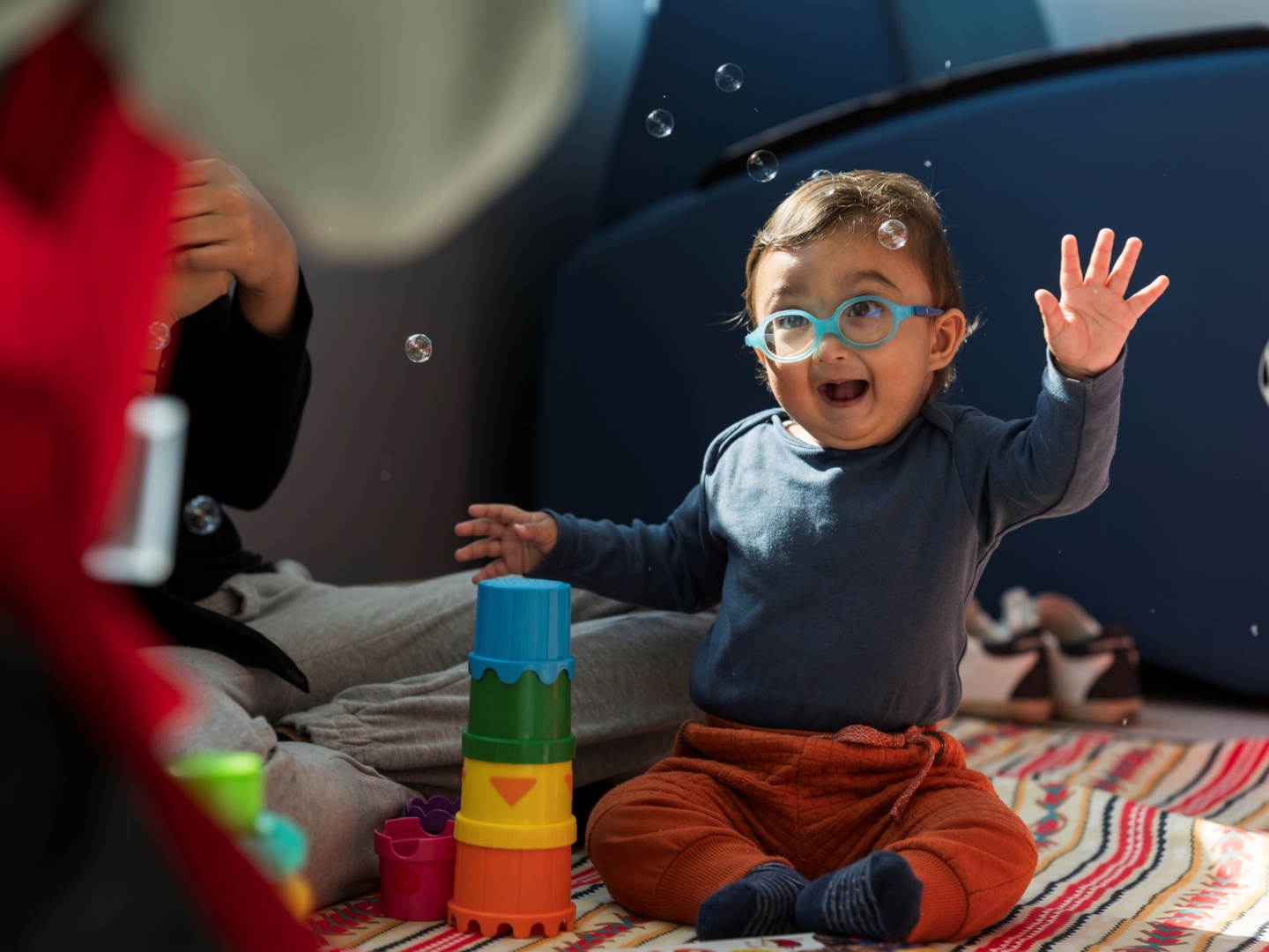 Zain plays with bubbles at an Operation Smile program.