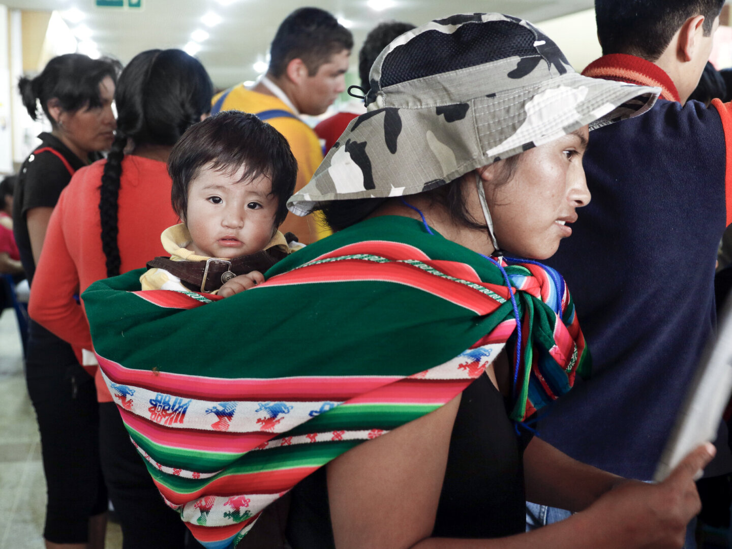 Andy, held by his mother, attends a program in Santa Cruz, Bolivia.