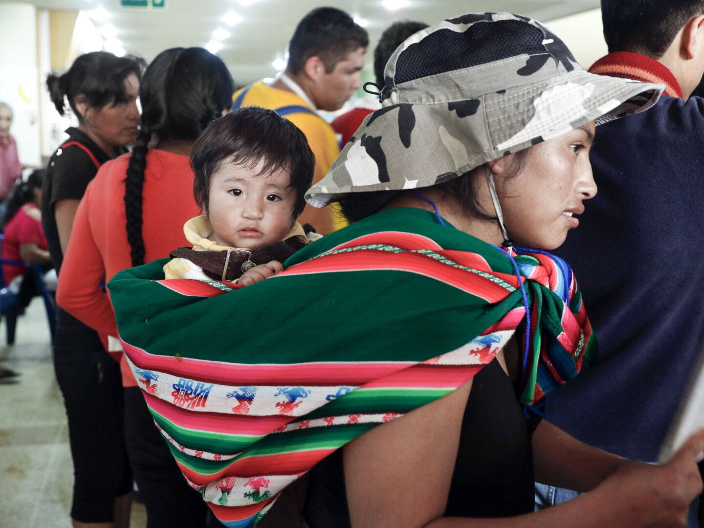 Andy, held by his mother, attends a program in Santa Cruz, Bolivia.