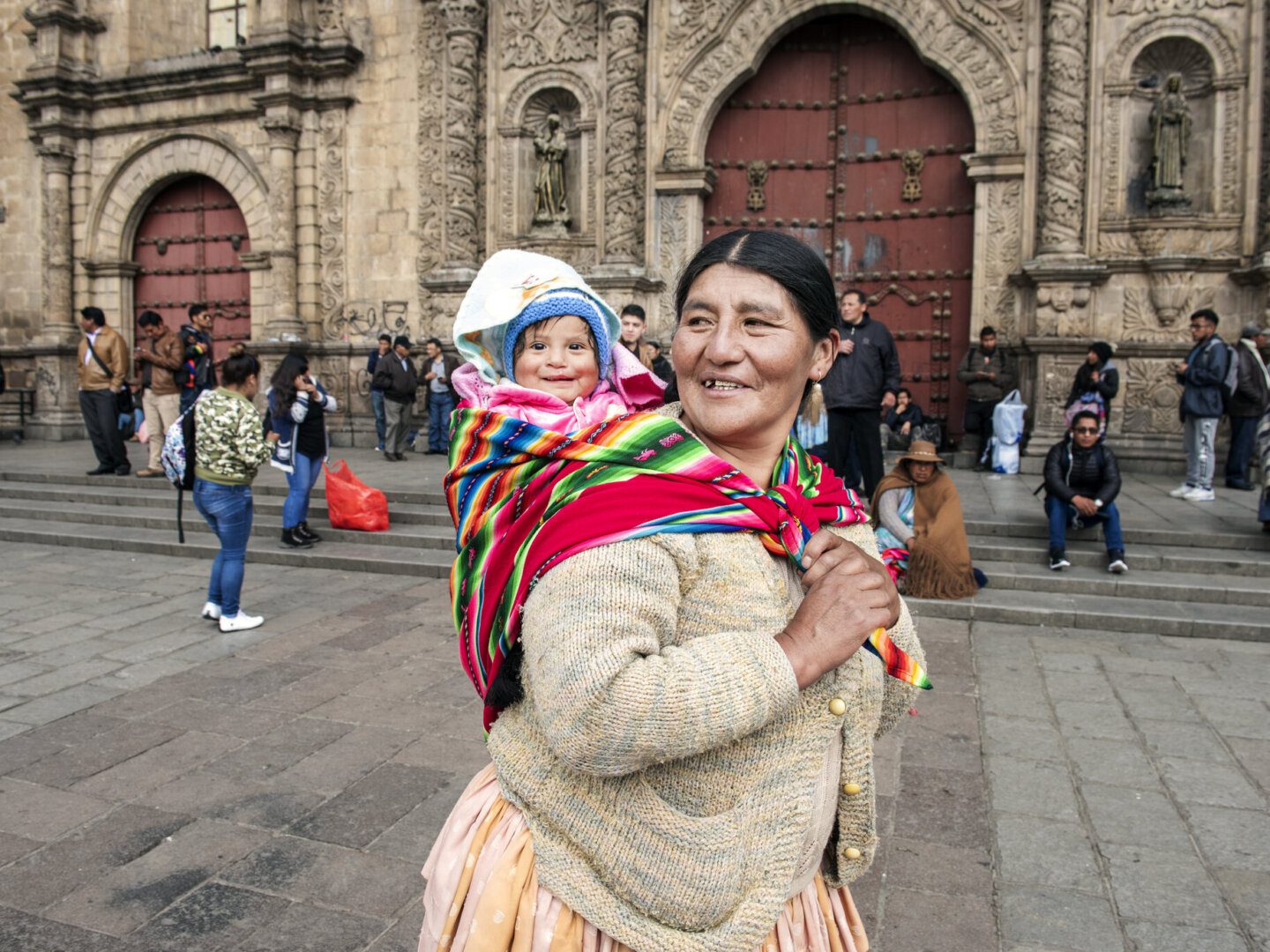 Heydi, held by her grandmother.
