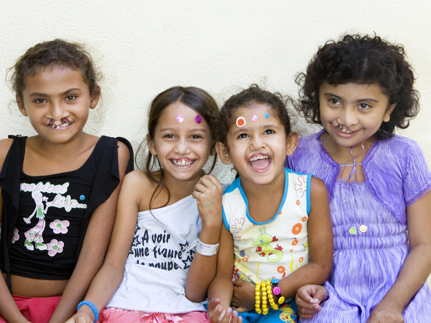 Antonia, pictured second, poses for a photo surrounded by fellow patients and friends during an Operation Smile Brazil surgical program to Fortaleza.