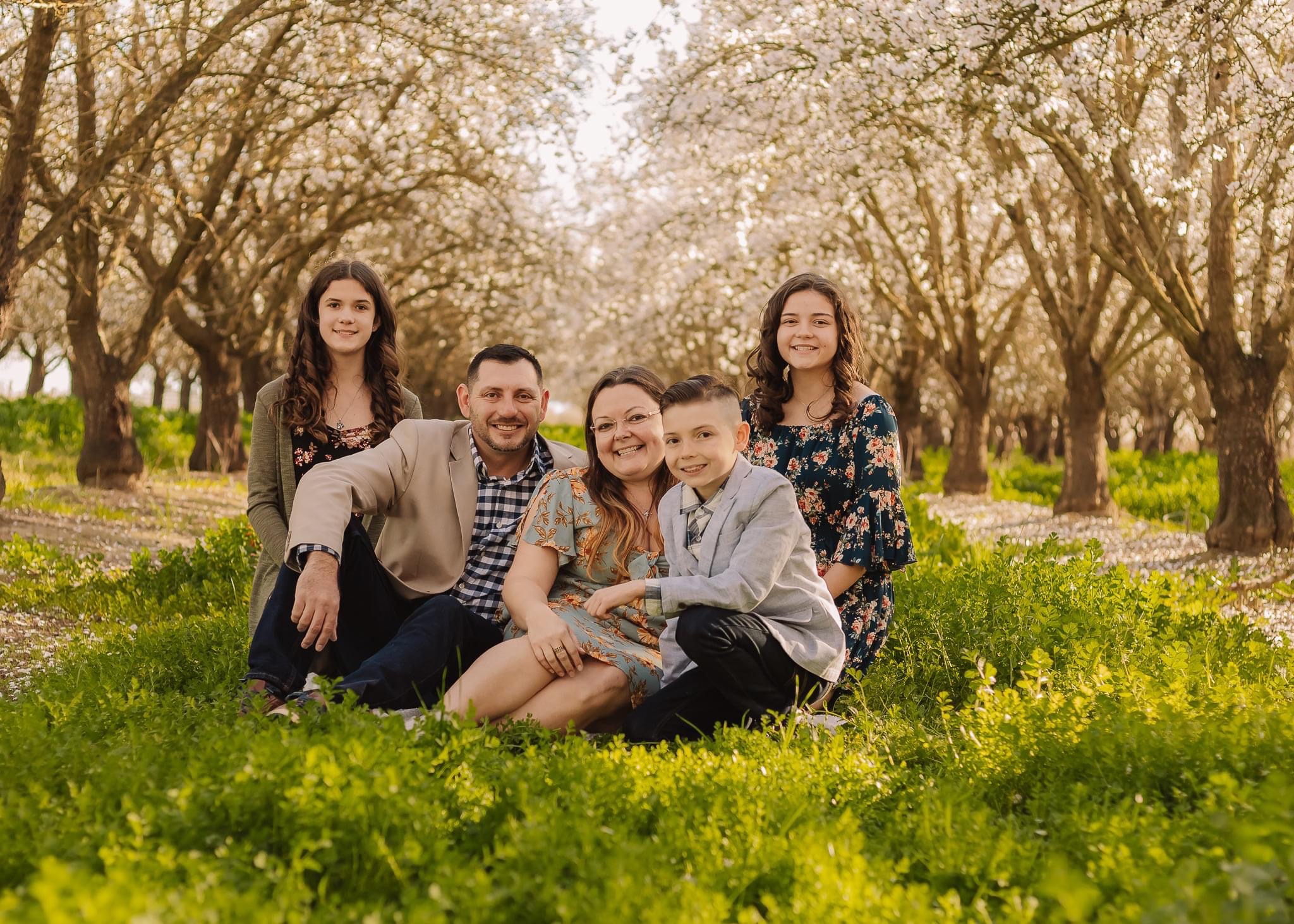dad, mom, and three children smiling