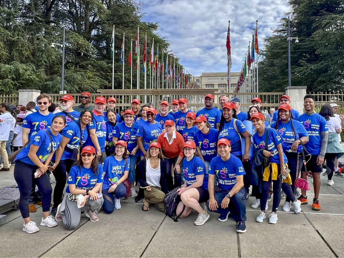 Operation Smile staff and volunteers smile at the camera while attending the 77th World Health Assembly.