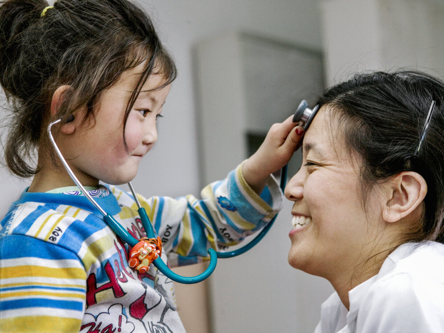 Pediatrician Heather Yang is examined by a patient during a surgical program in China.