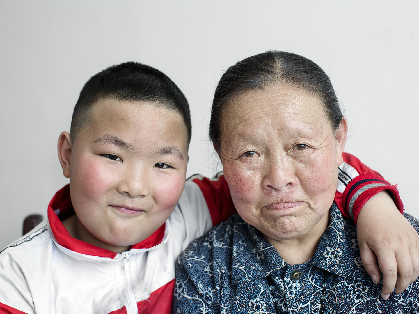 Qi Xiu smiles wide with her grandson.