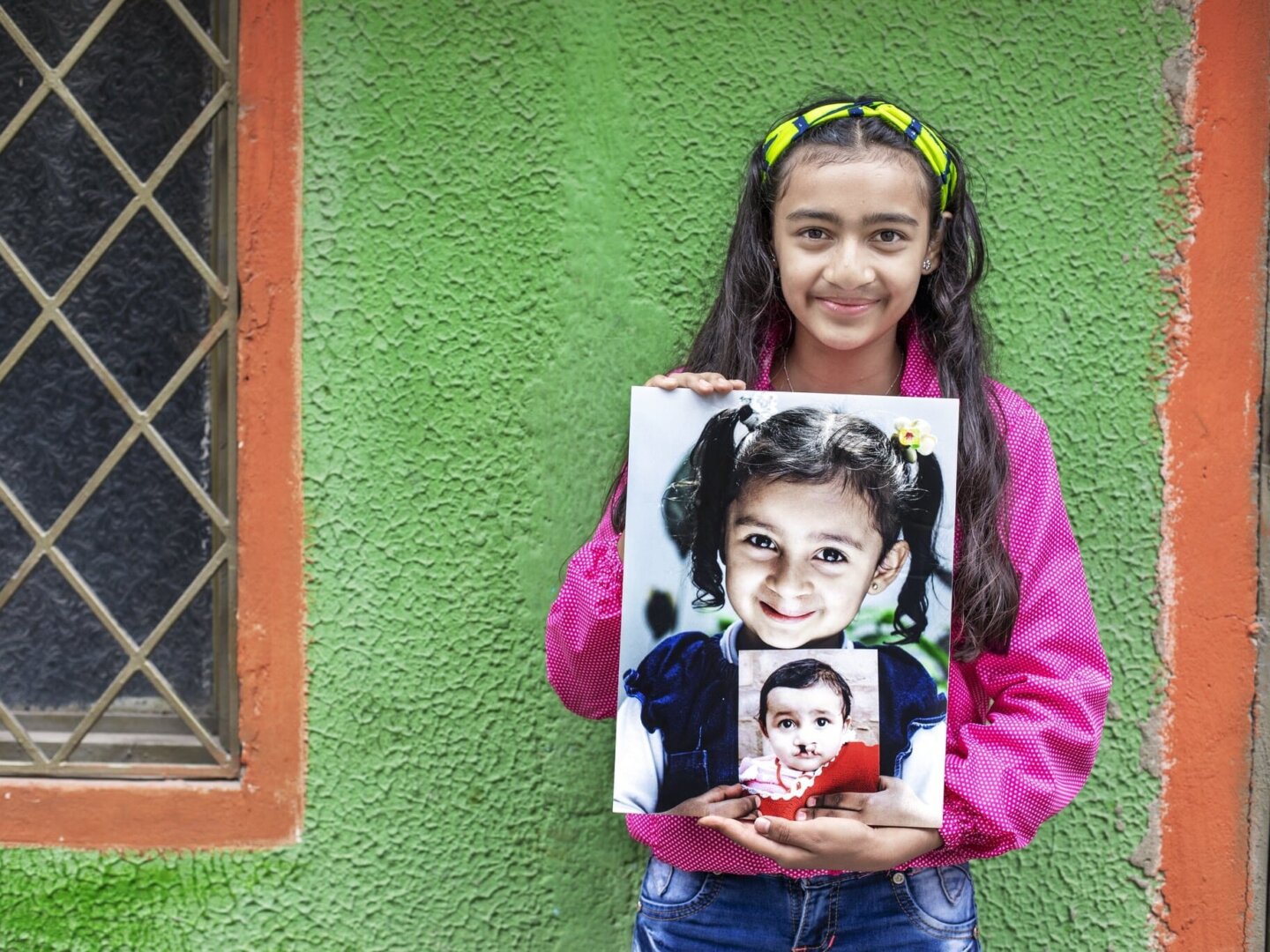 Laura holds both of her before photos.