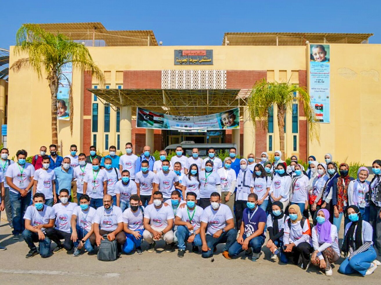 Operation Smile Egypt volunteers and Libyan volunteers come together and pose for a team picture in front of the Assiut University Pediatric Hospital.