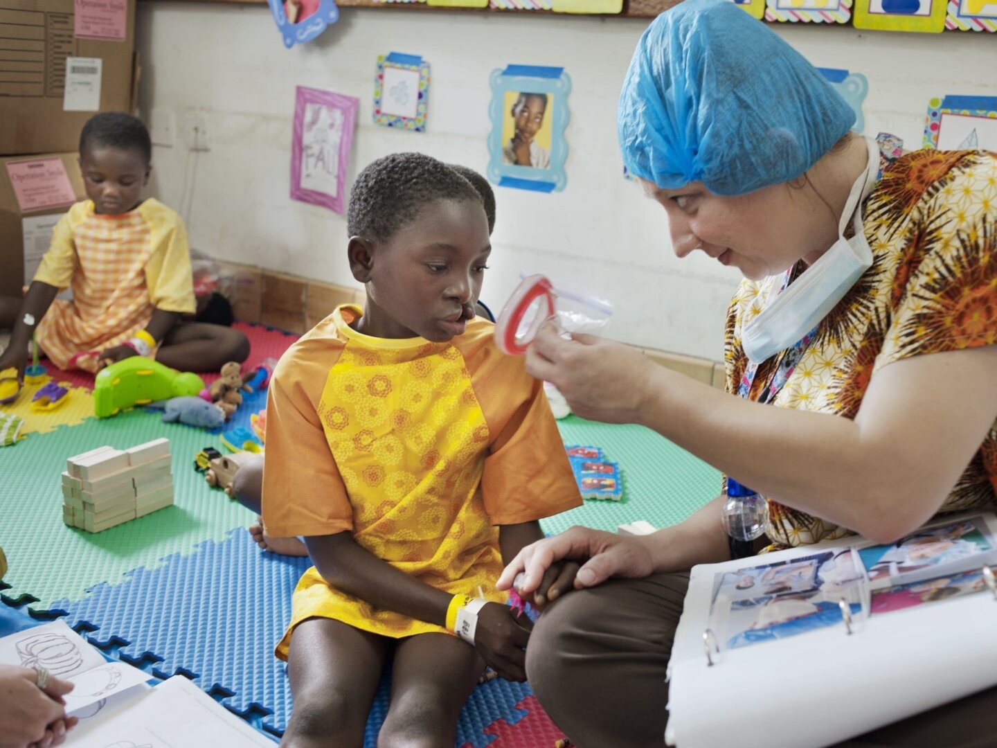 A patient and volunteer discuss anesthesia during a psychosocial care session in Ho, Ghana.