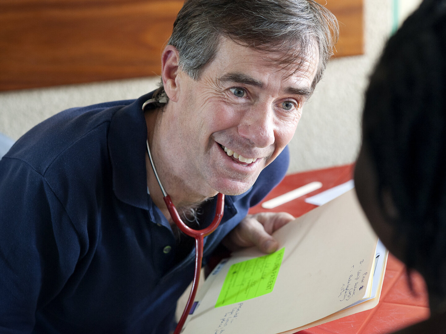 Anesthesiologist Phil McDonald speaks with a patient during a surgical program in Ho, Ghana.