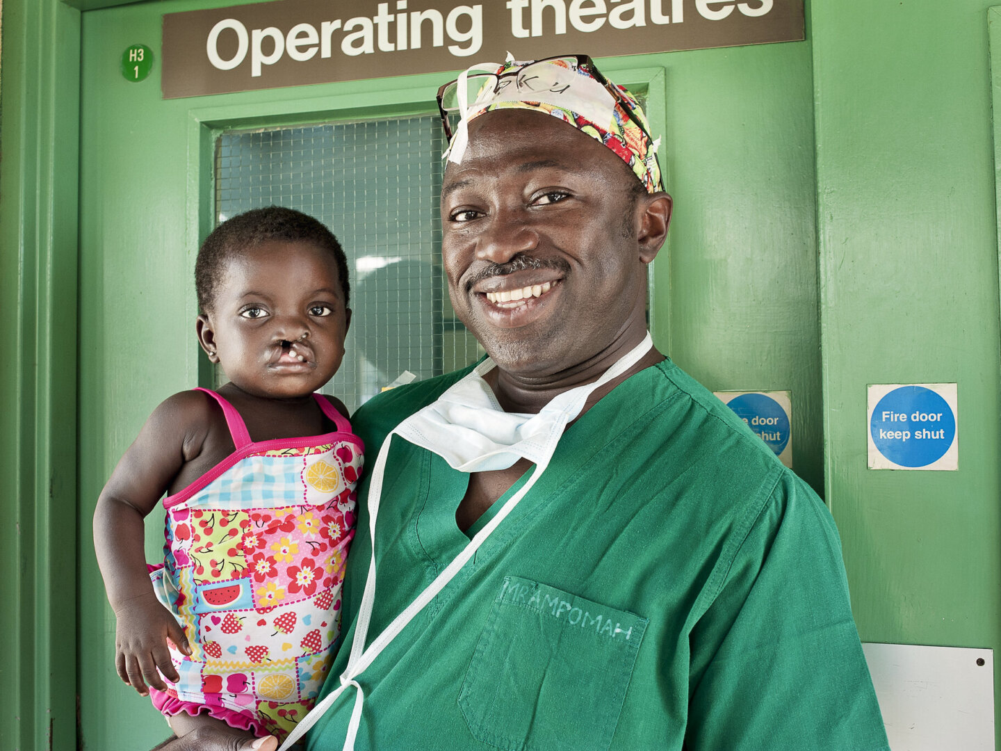 Dr. Opoku Ampomah smiles with a patient during a surgical program in Ho, Ghana.