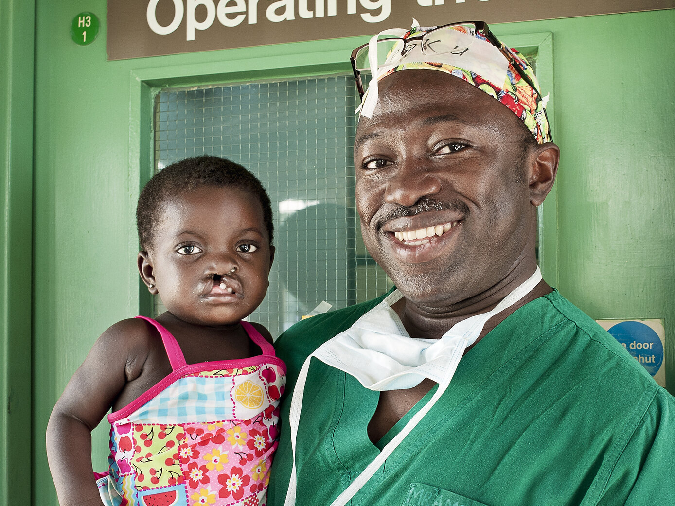Dr. Opoku Ampomah smiles with a patient during a surgical program in Ho, Ghana.