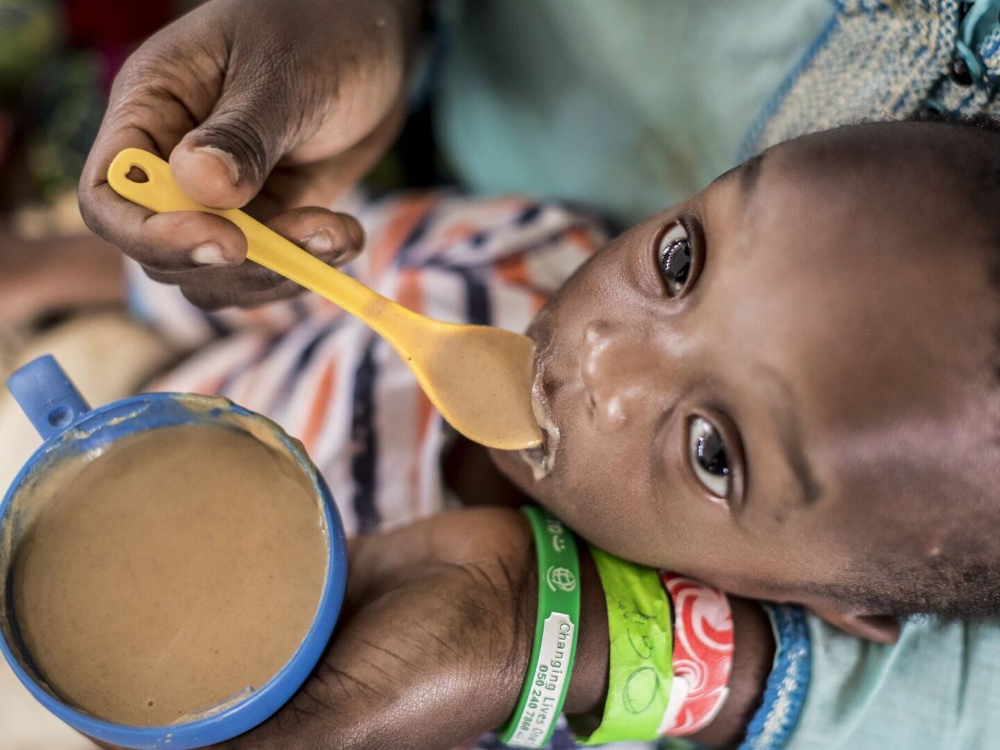 Nutritionist Dede Kwadjo feeds 1-year-old Nana.