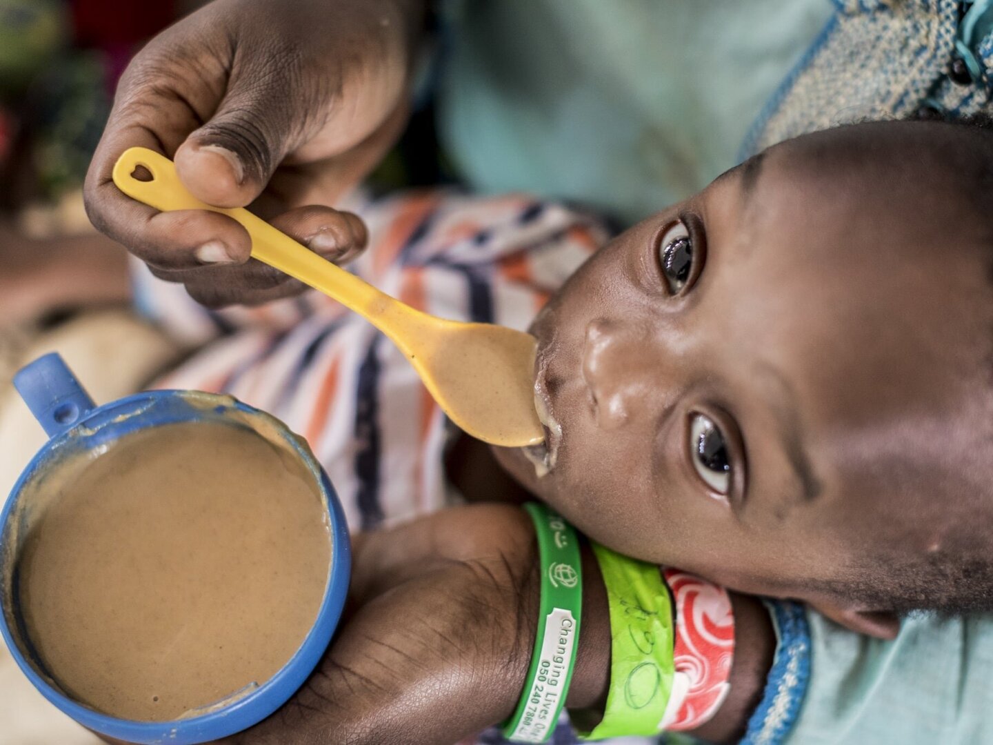 Nutritionist Dede Kwadjo feeds 1-year-old Nana.