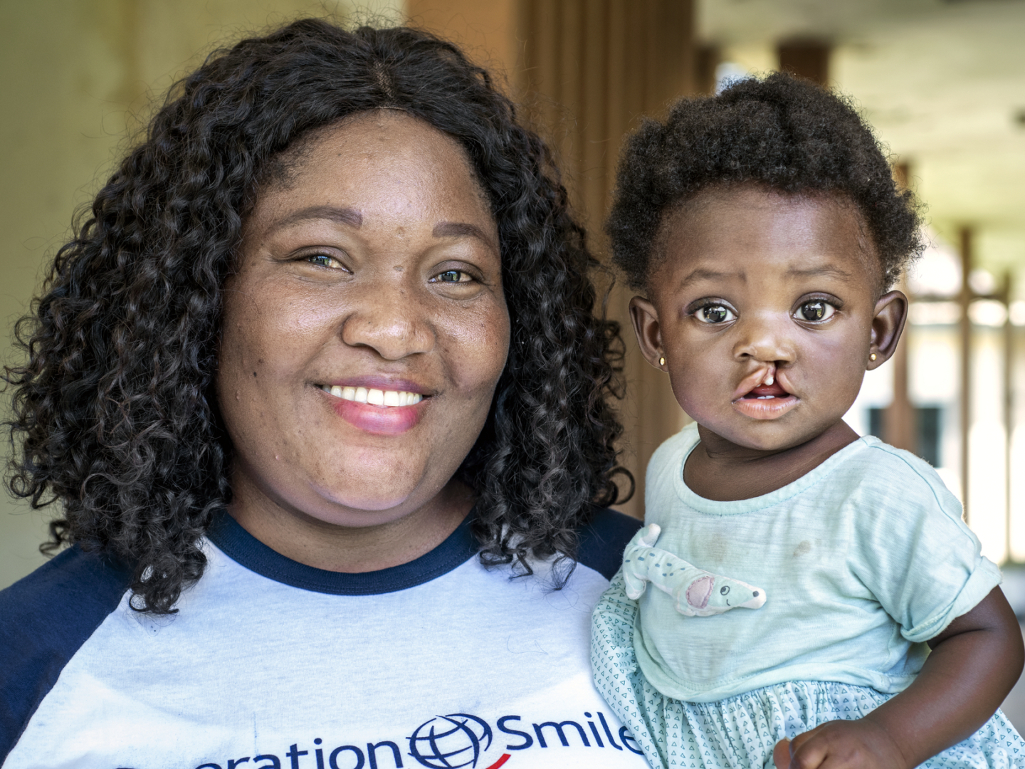 Irene Dzirasa smiles while holding 9-month-old Selina.