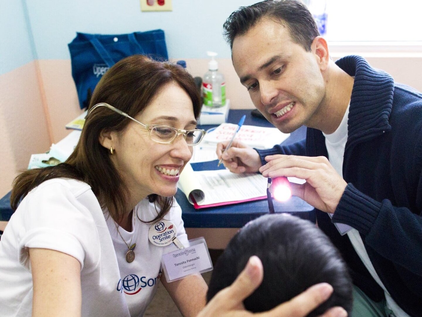 Operation Smile volunteers provide oral care to a patient.