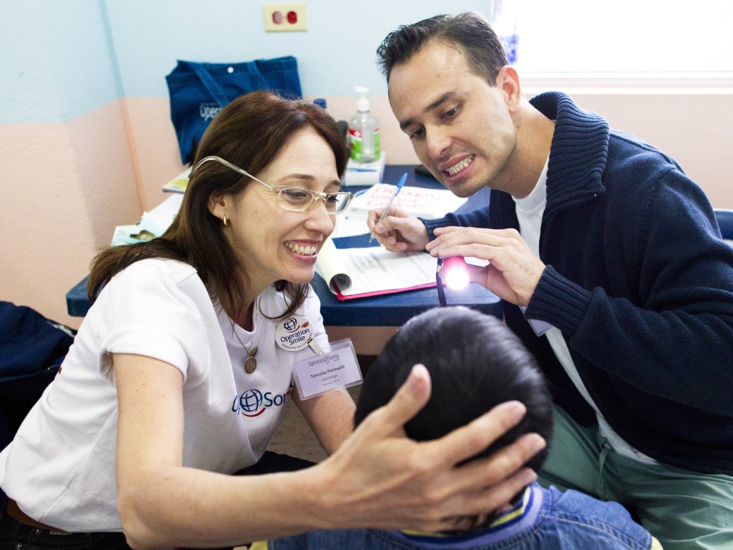 Operation Smile volunteers provide oral care to a patient.