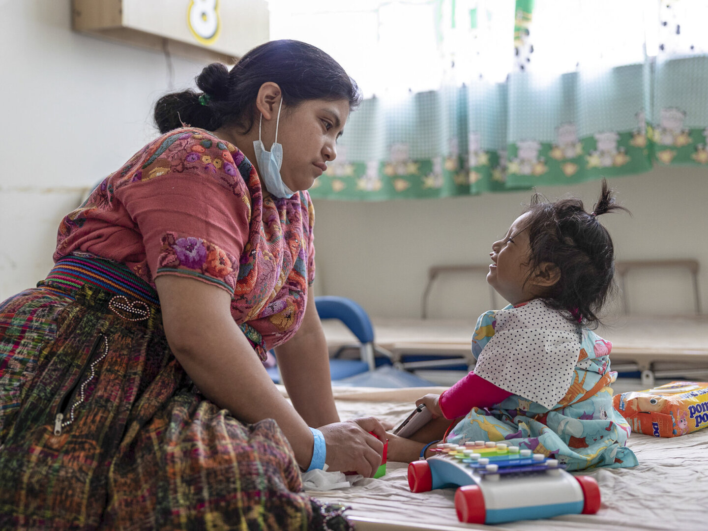 Heidy waits patiently with her 21-month-old daughter, Leyda, for the moment when volunteers will call her into the operating room.