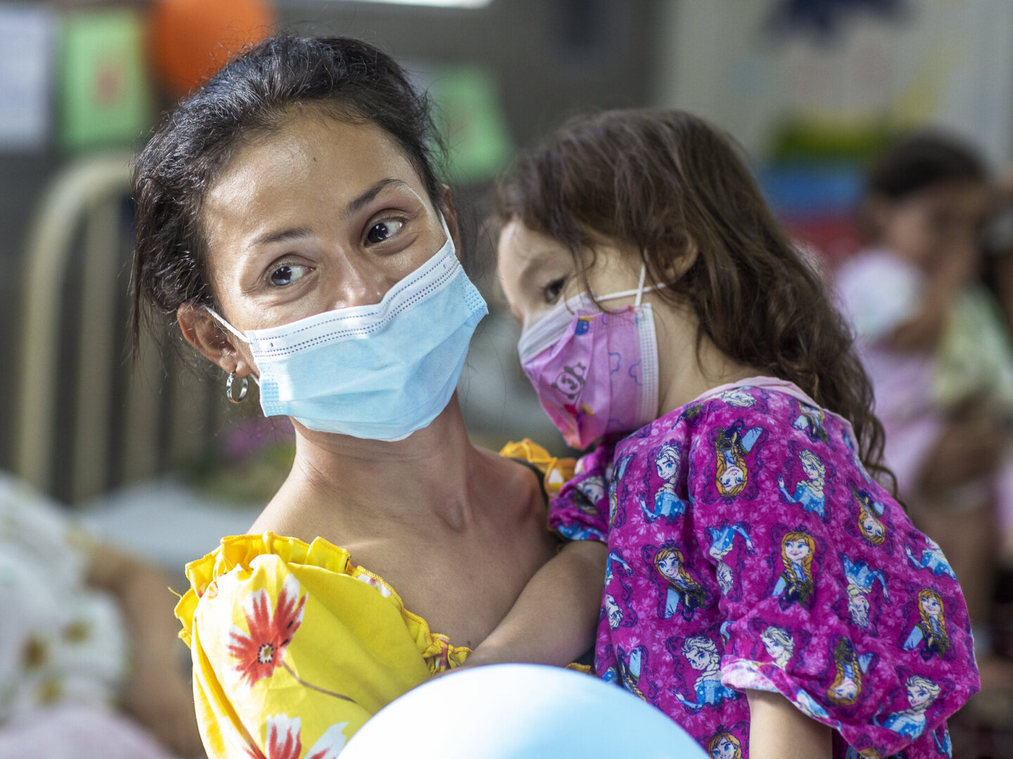 Ana, holds her daughter, Zoe, in the pre-operative ward during an Operation Smile Honduras surgical program.