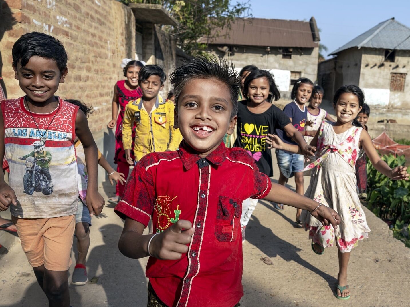 Shyam runs towards the camera with friends. His cleft condition was treated thanks to access to surgical care.