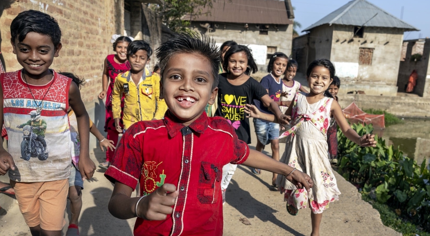 Shyam runs towards the camera with friends.