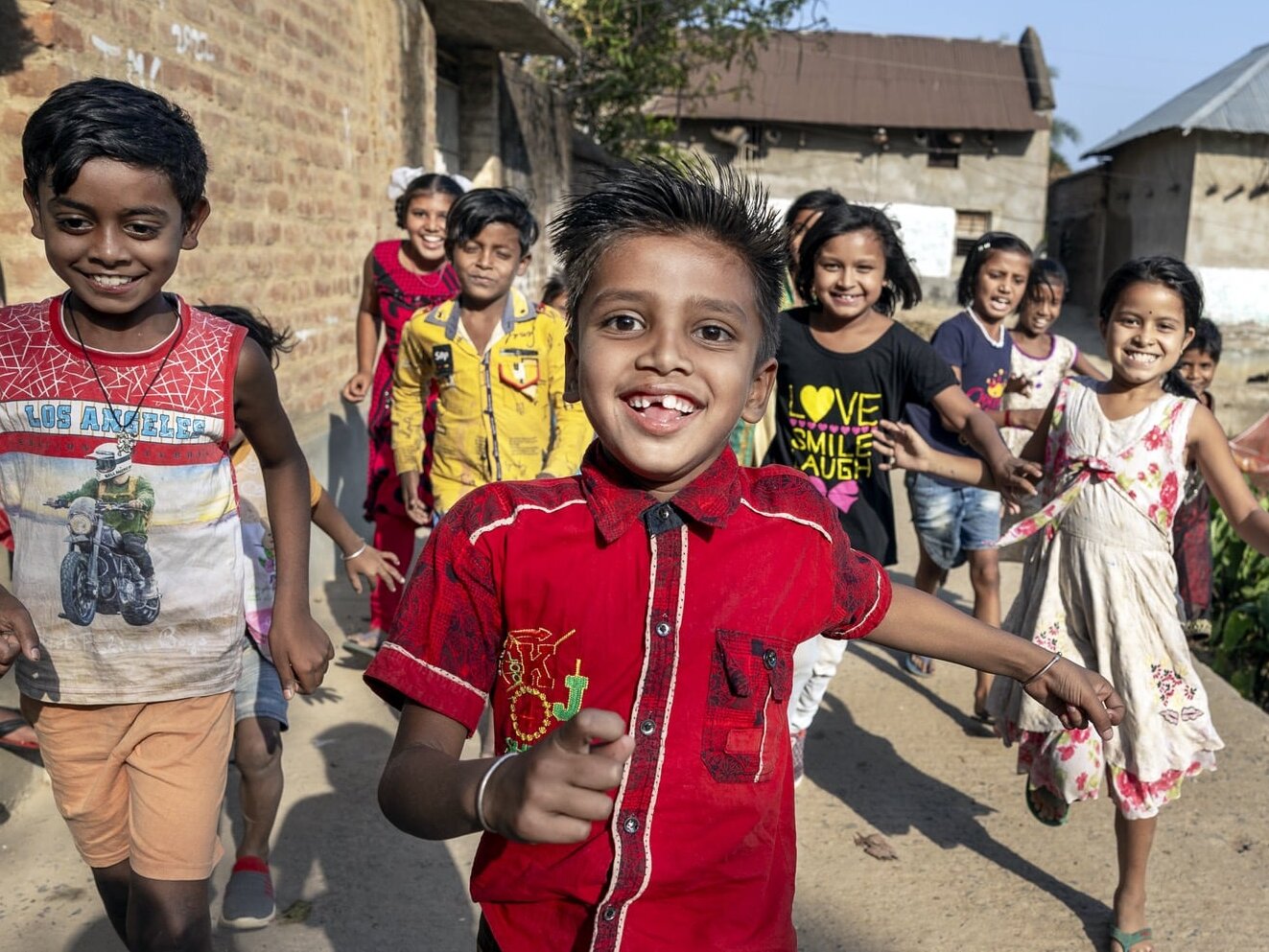 Shyam runs towards the camera with friends.
