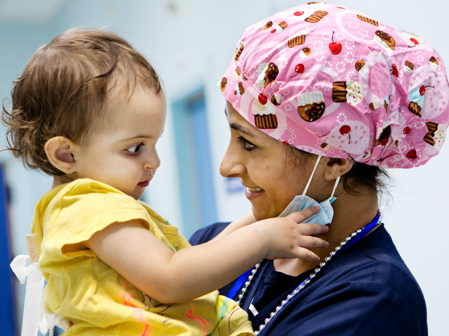 A patient plays with a volunteer's surgical mask during a program in 2013 in Jordan.