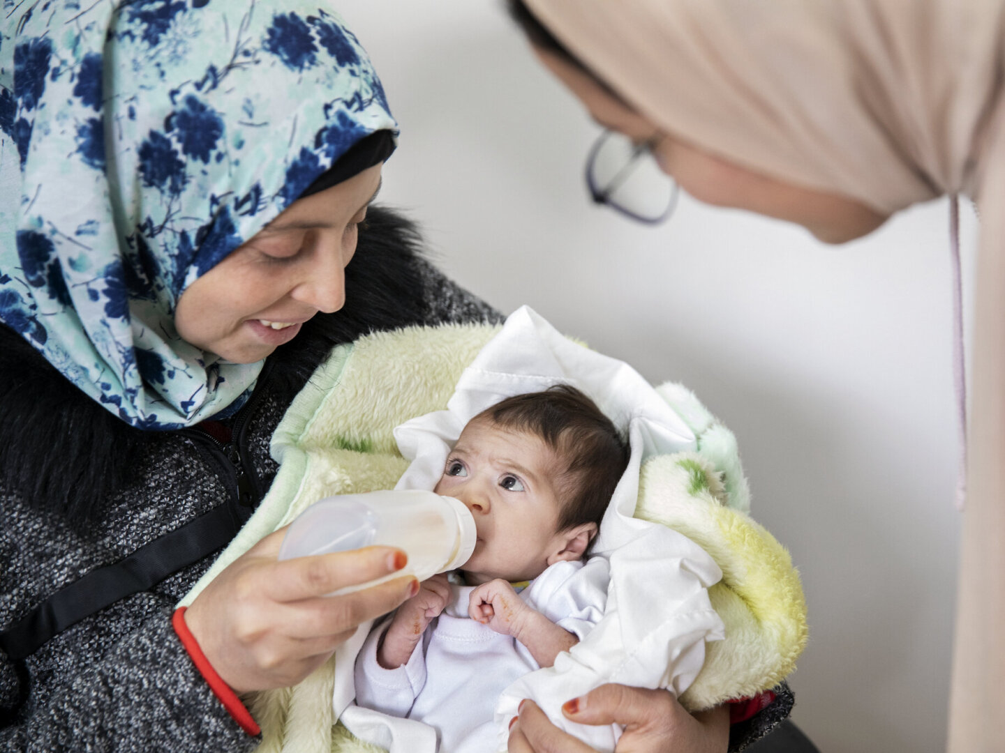 For perhaps the first time, Fatima watches as Janat drinks milk without choking thanks to her daughter’s new feeding plate.