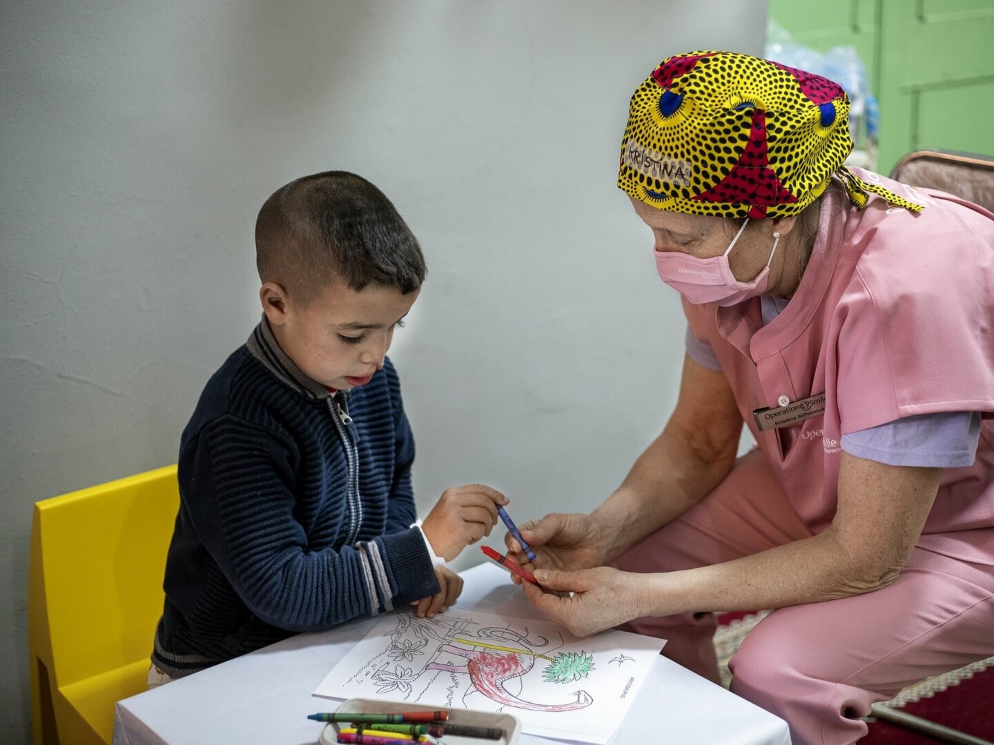 A patient and volunteer color during time dedicated to psychosocial care during a program in 2022 in Morocco.