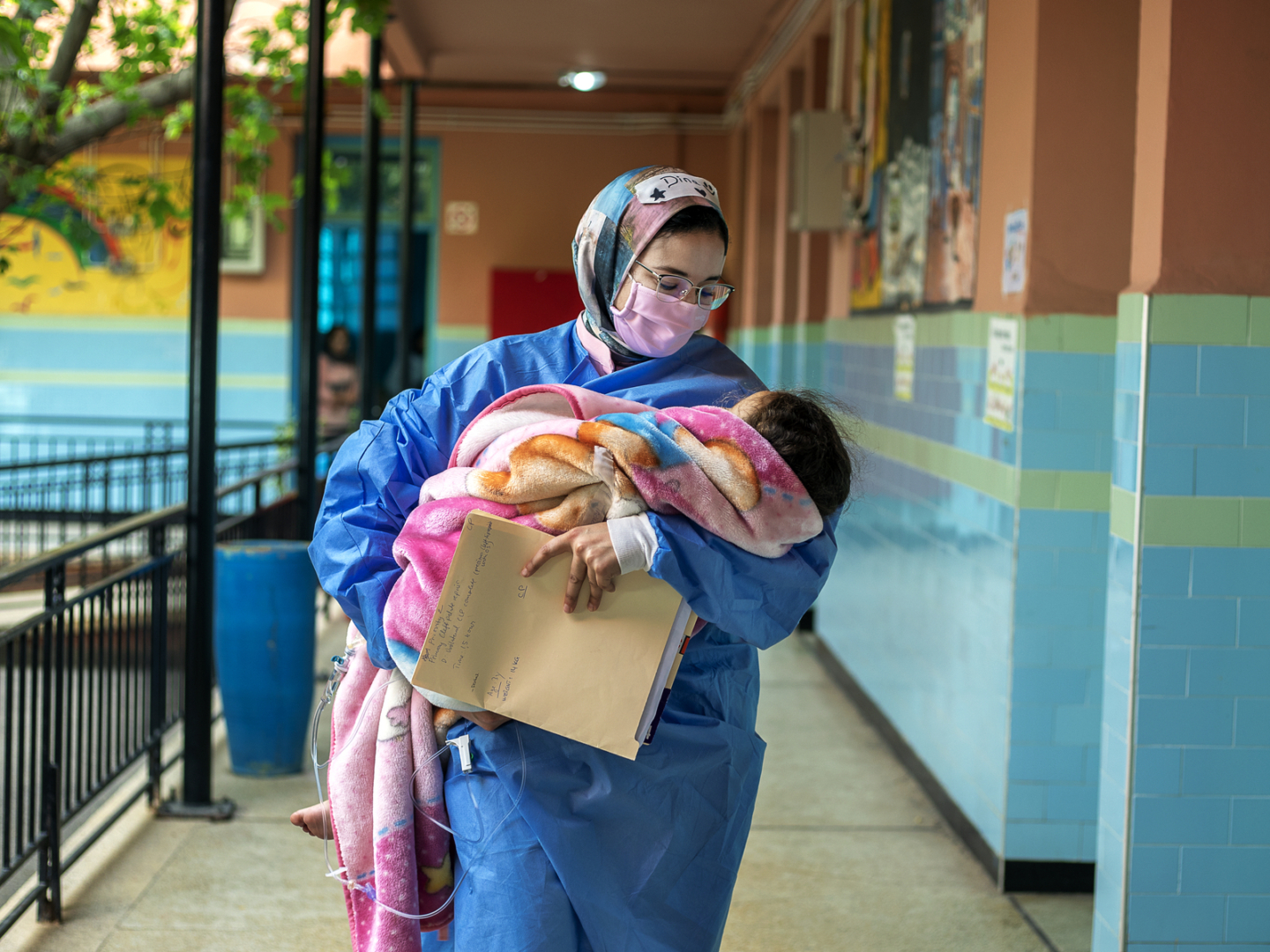 Nurse Dina Kouhous walks with a patient during a surgical program in Morocco.