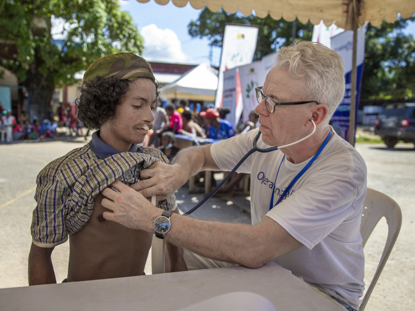An Operation Smile volunteer listens to Nono's heart.