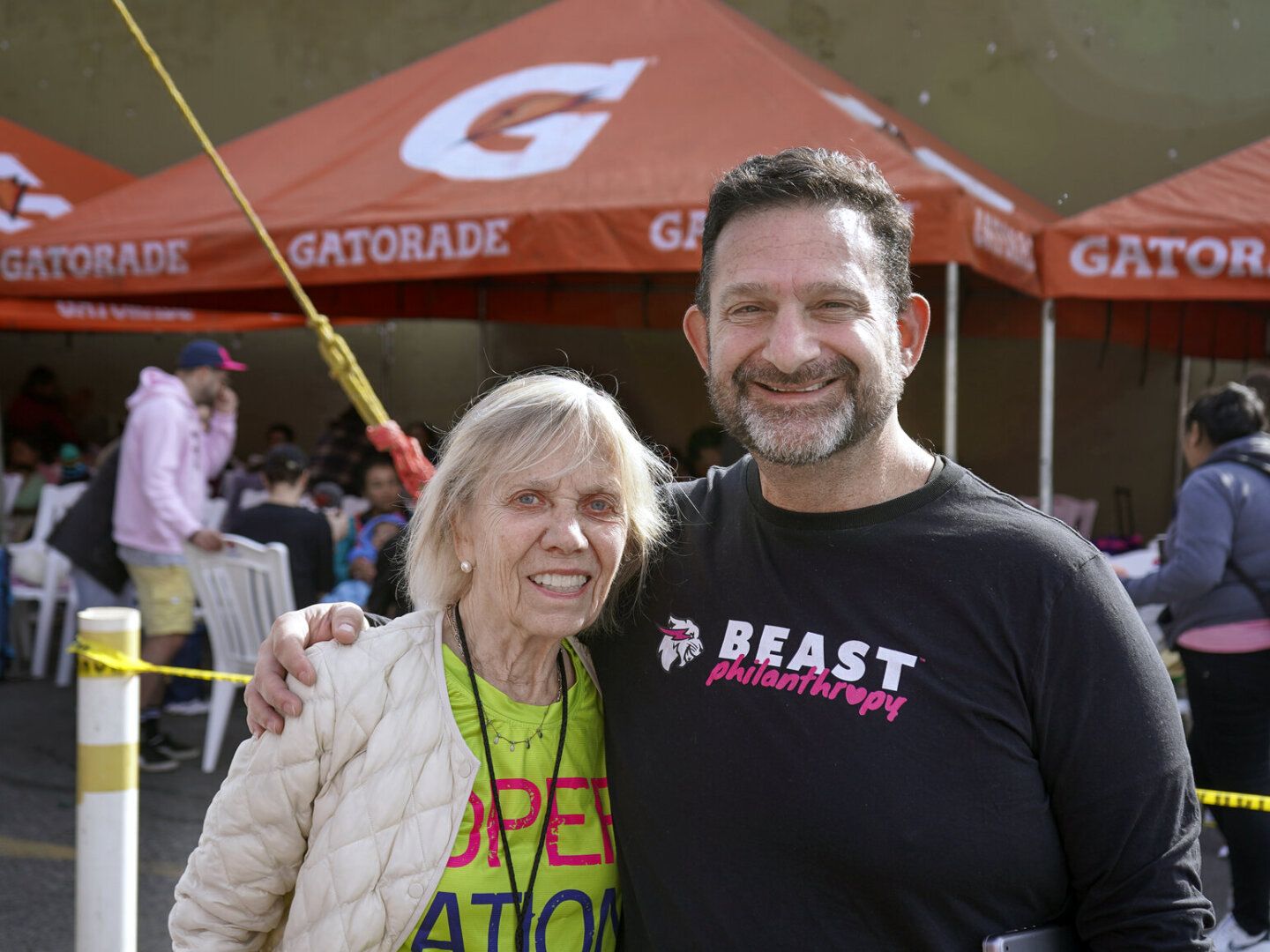 Kathy Magee stands with Beast Philanthropy staff member Darren