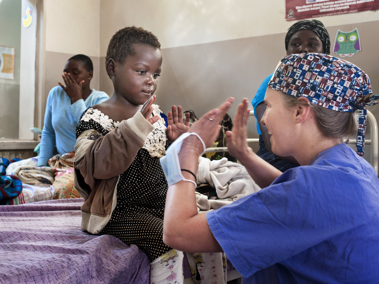 Ziyalesi gives a high 10 to an Operation Smile volunteer after surgery.