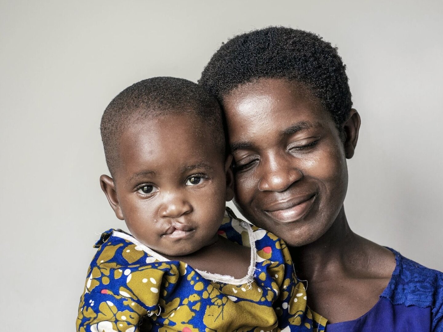 Julita snuggles with her mom before surgery.