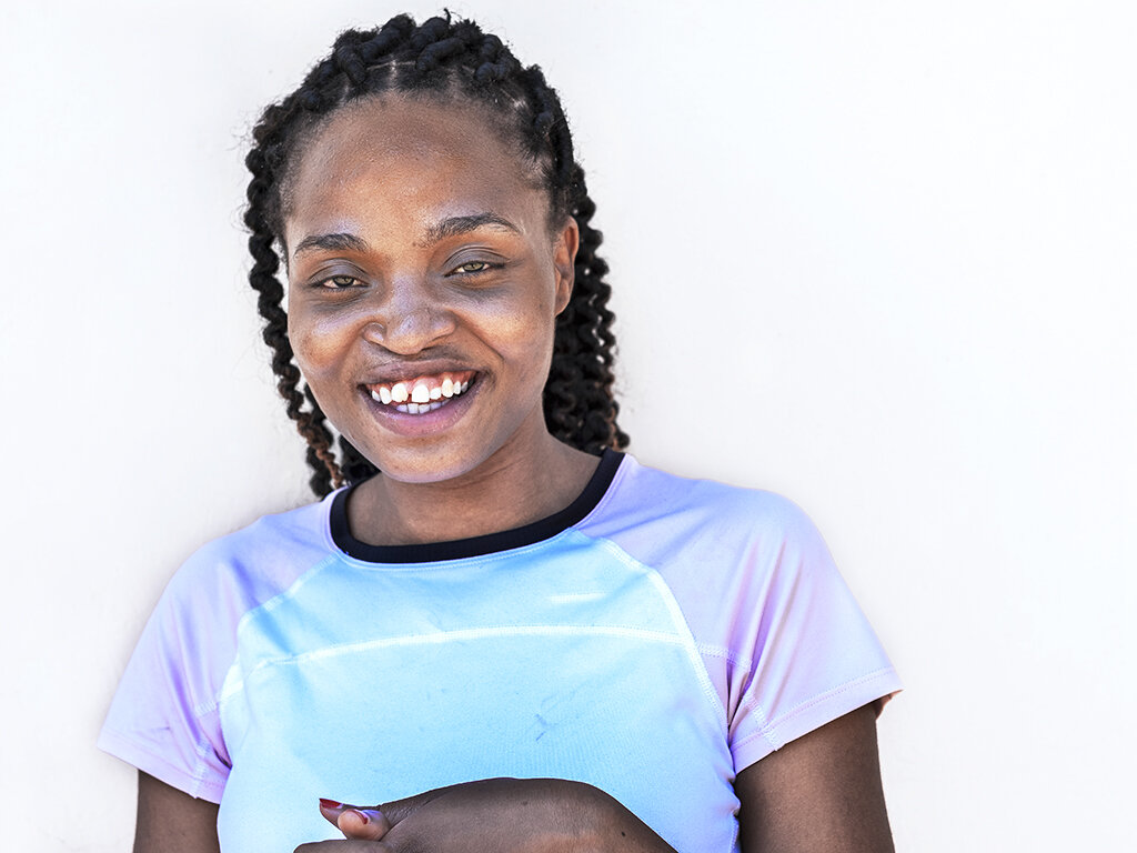 Operation Smile Malawi volunteer Carol Chigona smiles for the camera.