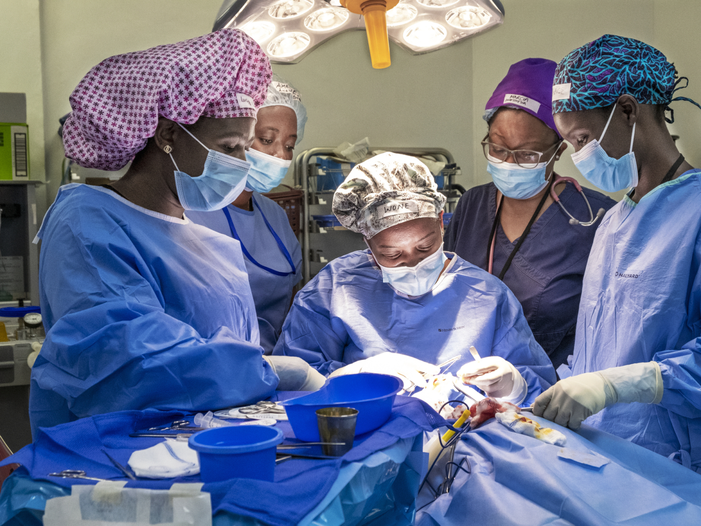 In the operating room during a Women in Medicine surgical program, cleft surgeon Dr. Wone Banda, center; surgical scrub personnel, Lucy Dodoli, left; pre- and post-operative nurse Grace Chirwa, right; and anesthesiologist Dr. Amelie Kamagaju, back left, working together as an all-female surgical team