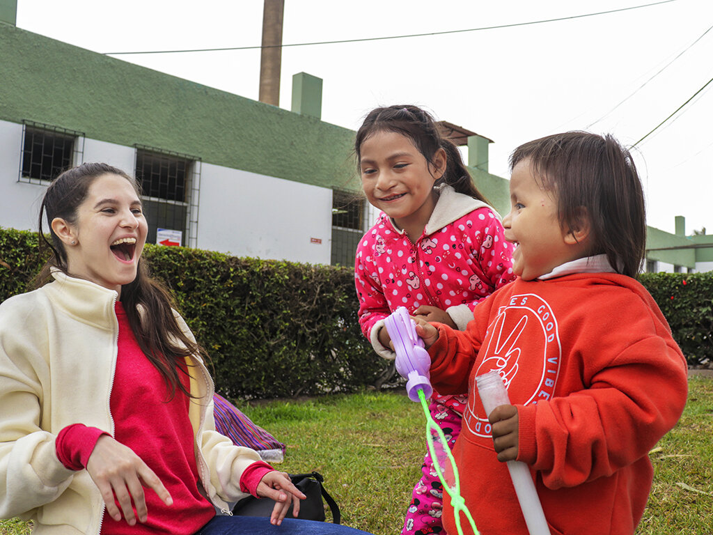 Katherine plays with children on screening day.