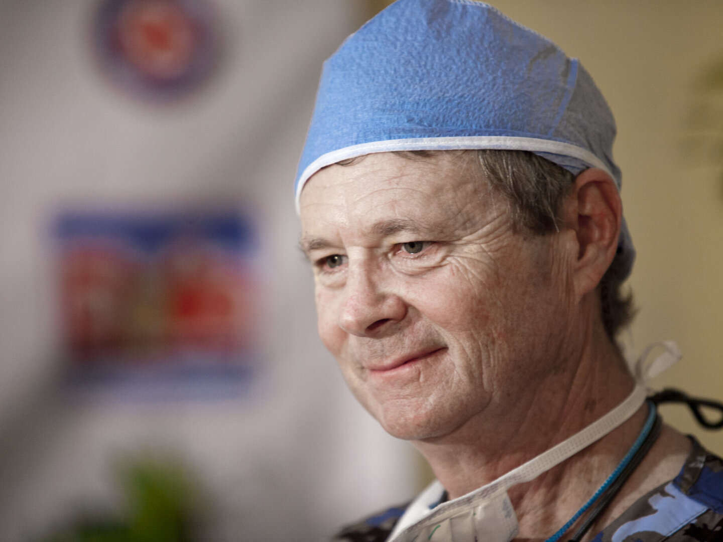 Bill Magee smiles softly during a surgical program in the Philippines. He co-founded Operation Smile, which works to increase access to care and global health equity.