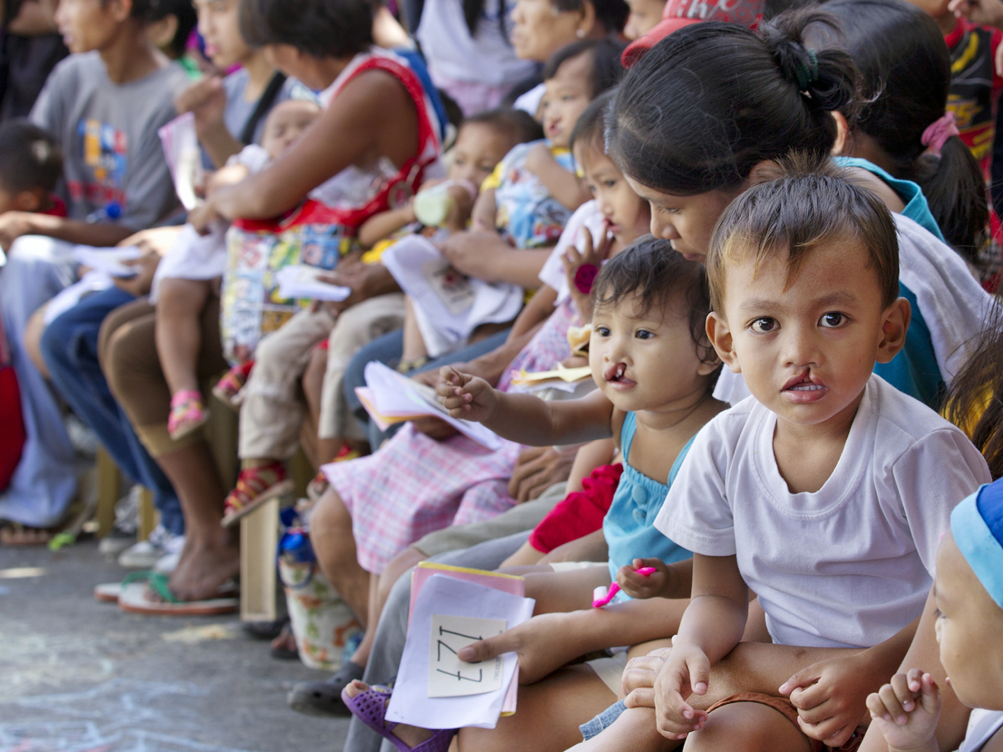 Hundreds wait for care during a surgical program in the Philippines.