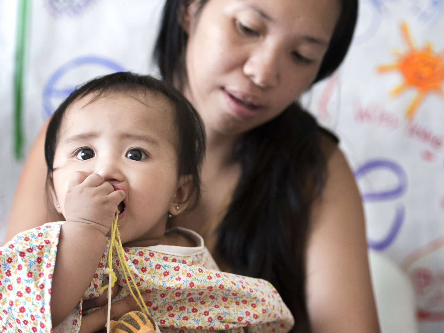 Enly chews a toy during a surgical program in the Philippines.