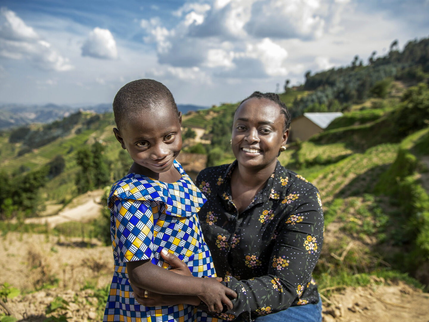 Dr. Francoise Mukagaju smiles at the camera with one of her patients, Valentine.