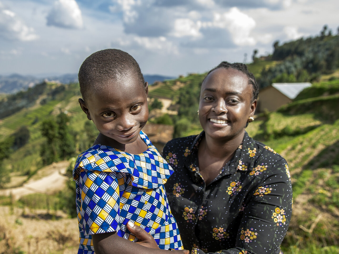 Dr. Francoise Mukagaju smiles at the camera with one of her patients, Valentine.