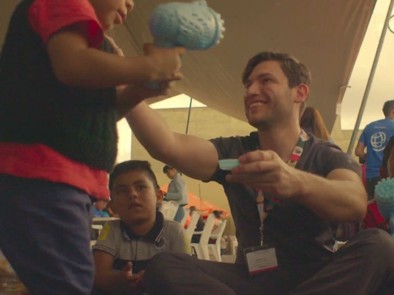 A surgical resident plays with children during a program in Puebla, Mexico.