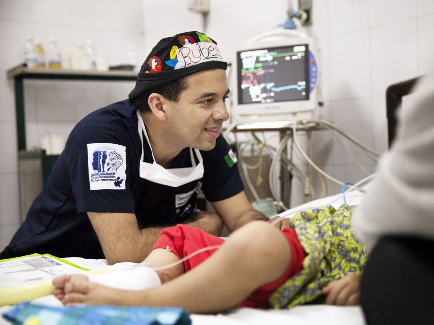 Dr. Ruben Ayala speaks with a patient's family after surgery.