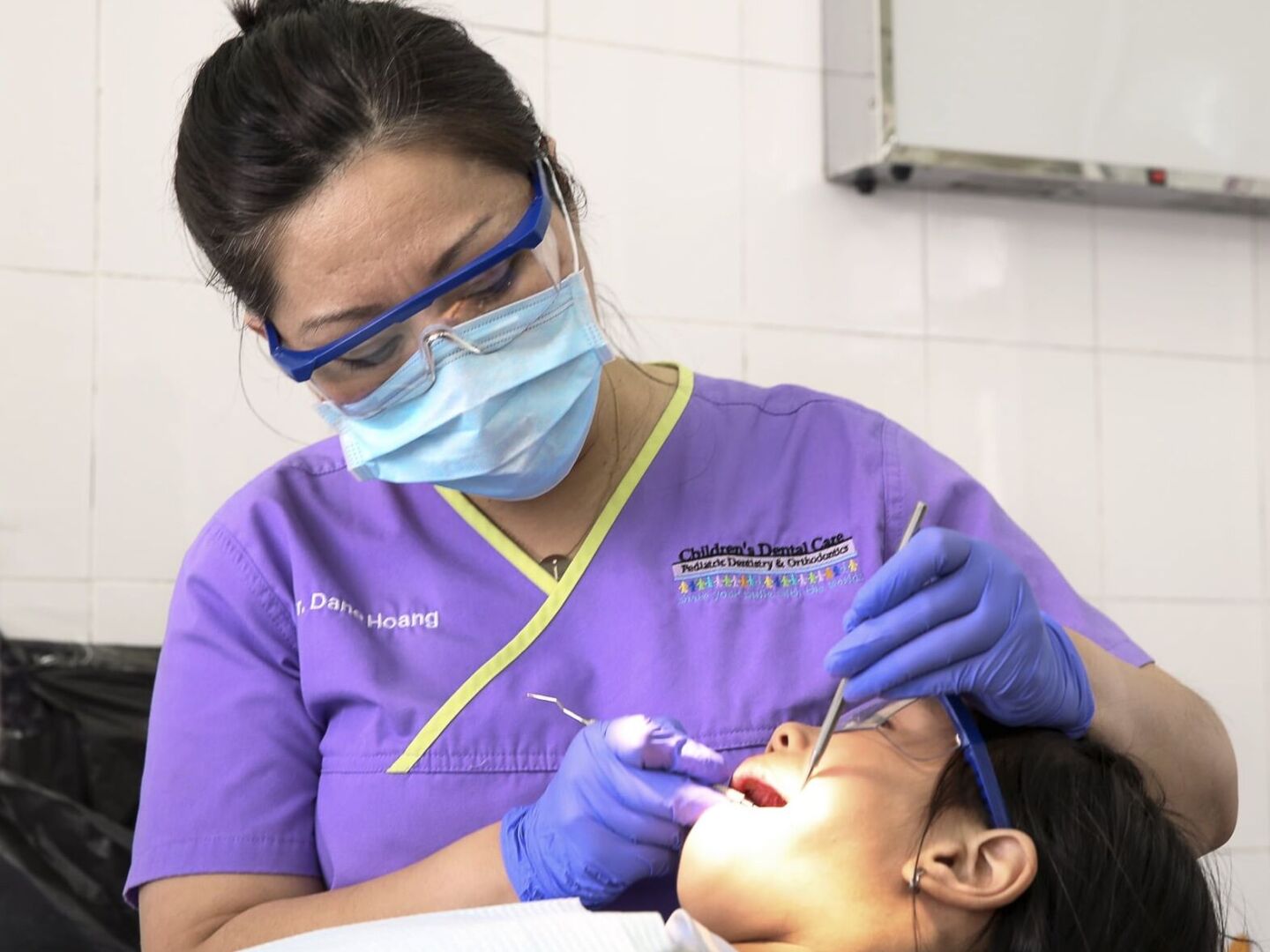 Dr. Dane Hoang provides a patient with dentistry during the 2016 Operation Smile dental program at Hue Odonto-Stomatology Hospital in Hue, Vietnam.