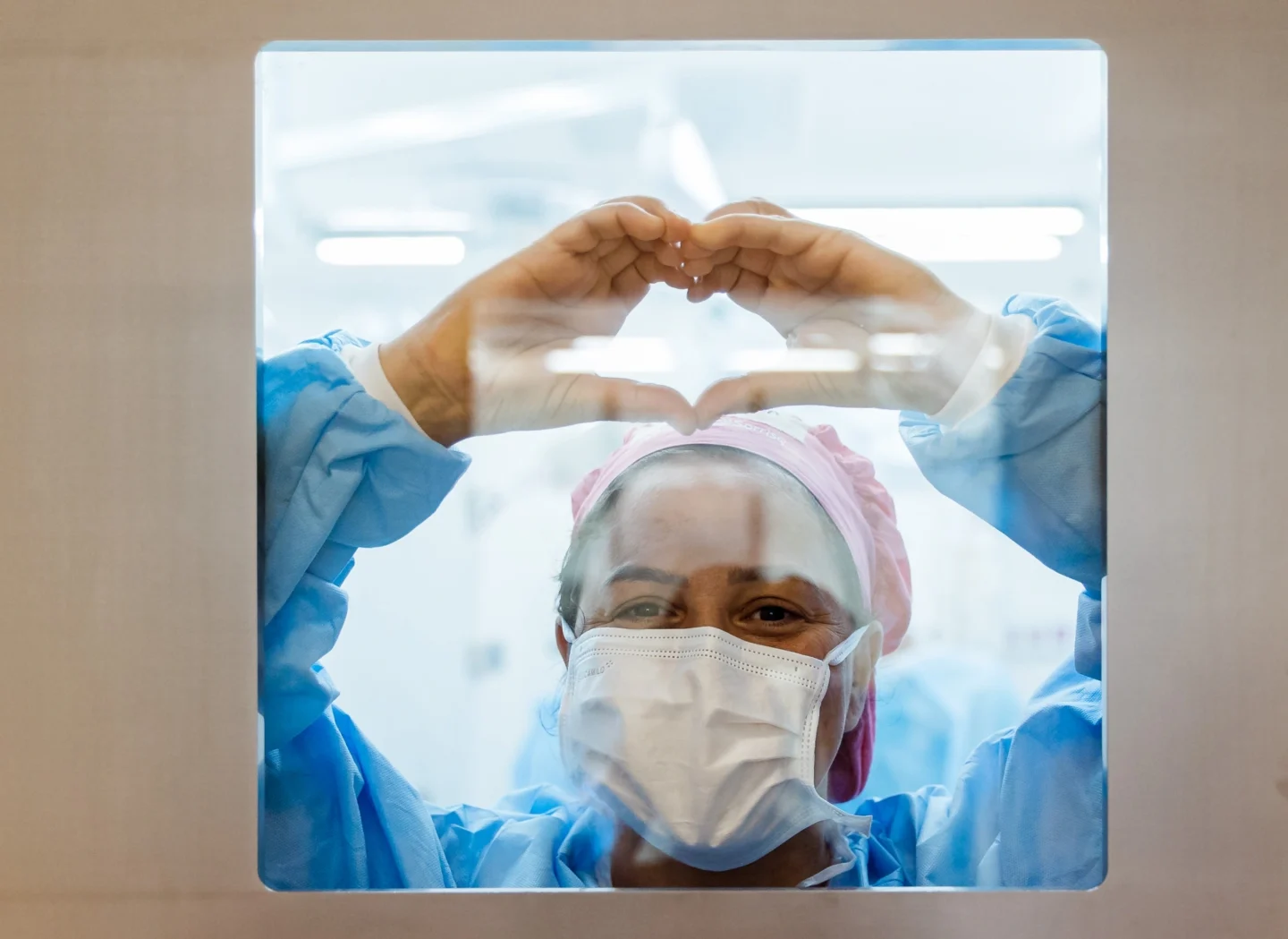 A volunteer makes a heart on the door at the Women in Medicine program in Brazil.