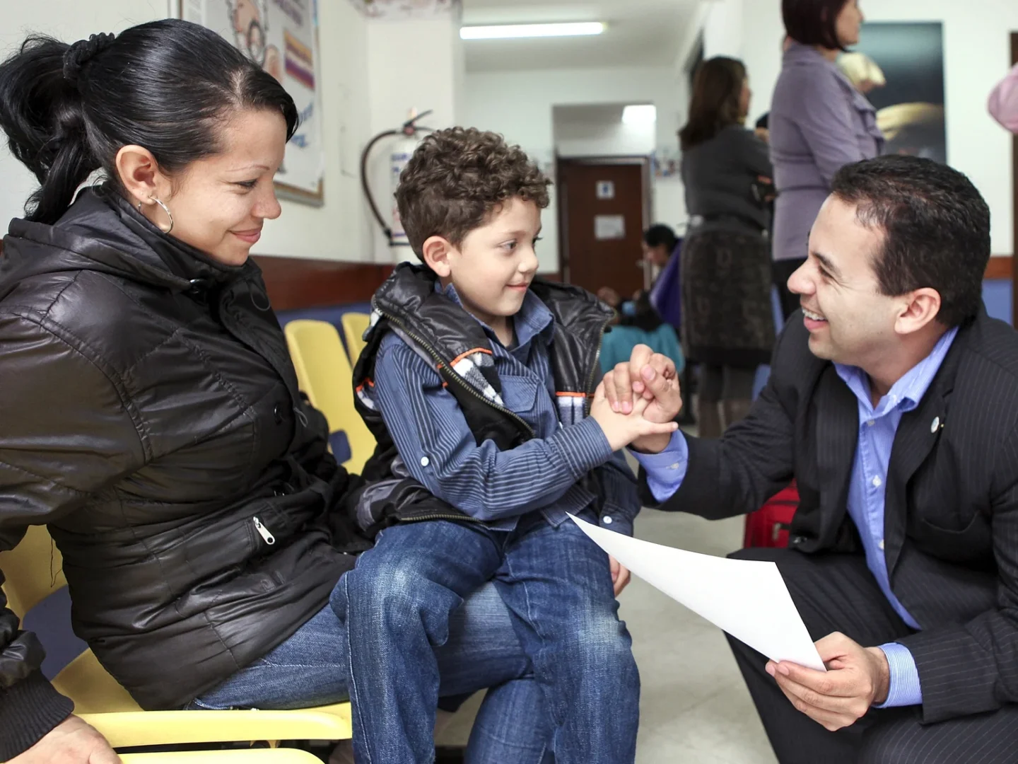 Ruben Ayala speaks with a patient and his mother.