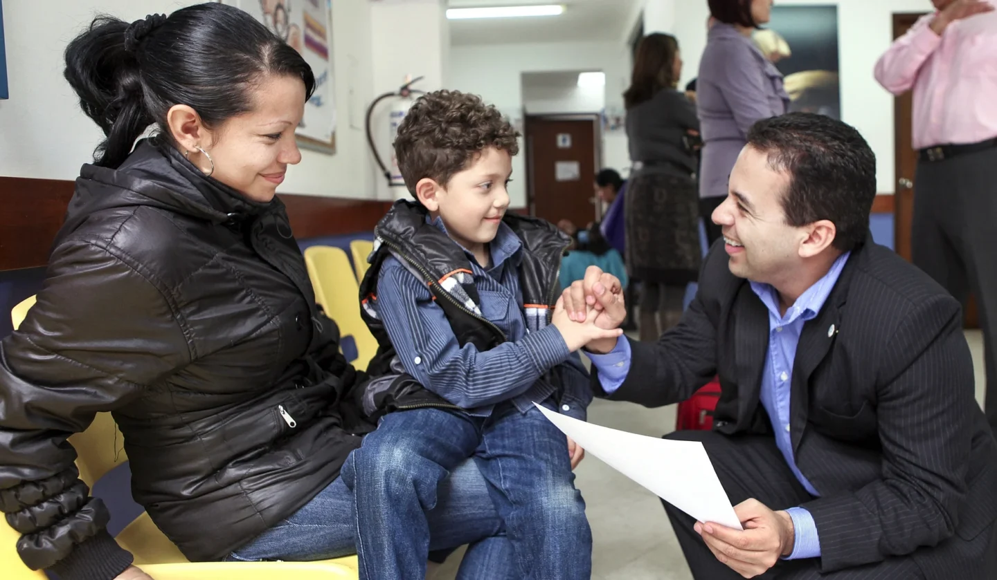 Ruben Ayala speaks with a patient and his mother.