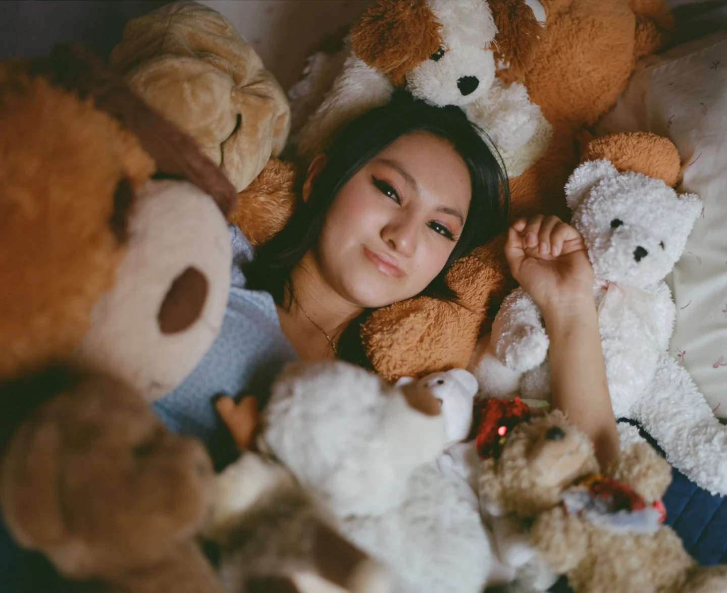 Palisha, among the stuffed animals she's received from Operation Smile over the years.