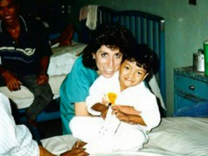 A volunteer smiles with a patient.