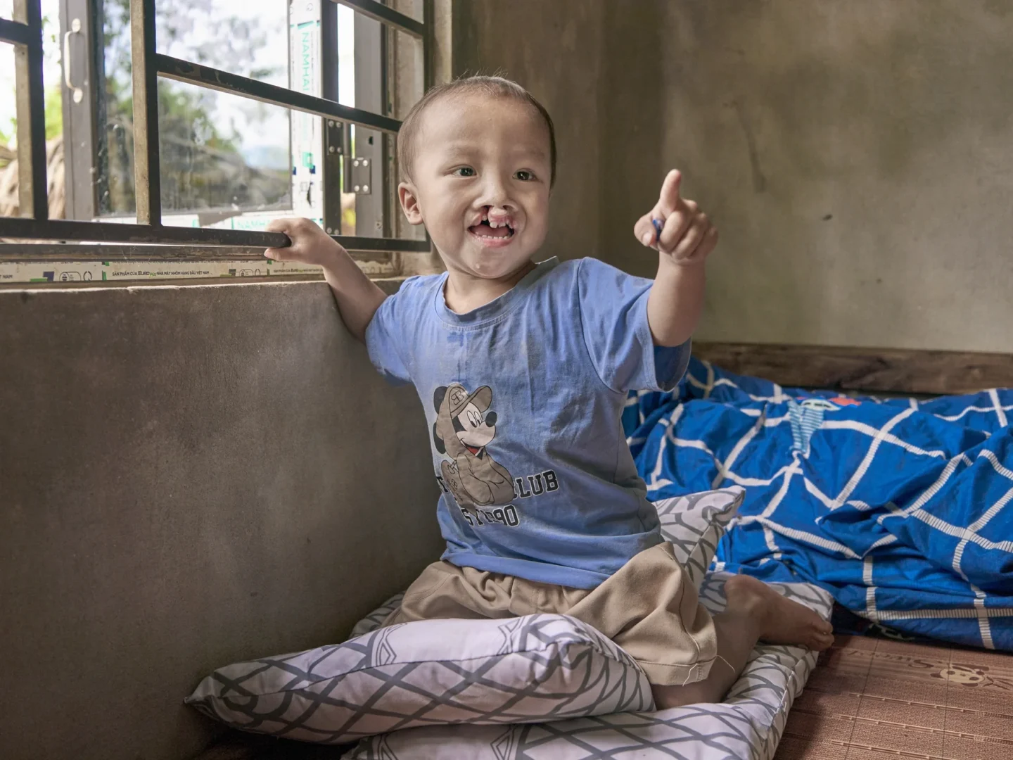 A boy excitedly points at something off camera.